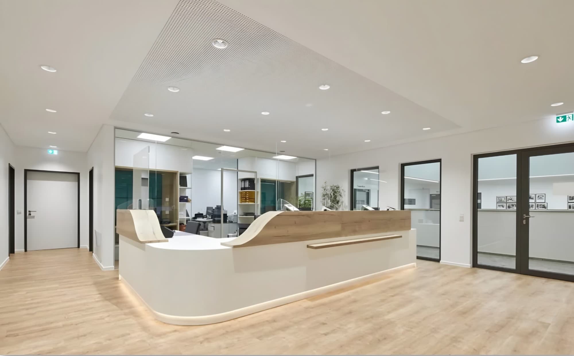 Office reception with a curved desk on a pale seamless floor