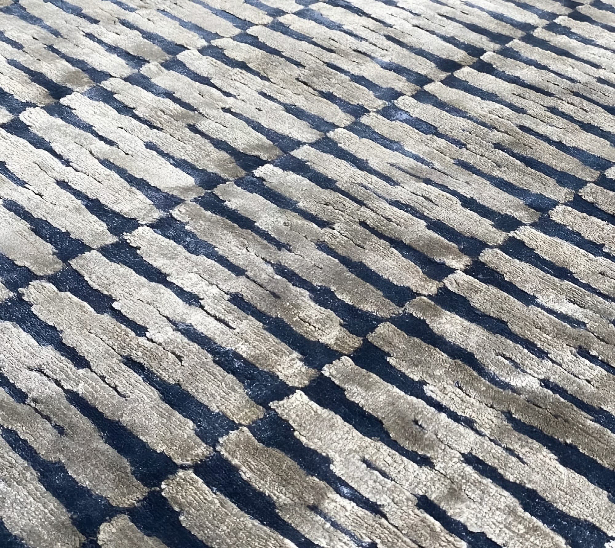 Detail of a hand-tufted rug with a diagonal cut-and-loop pattern