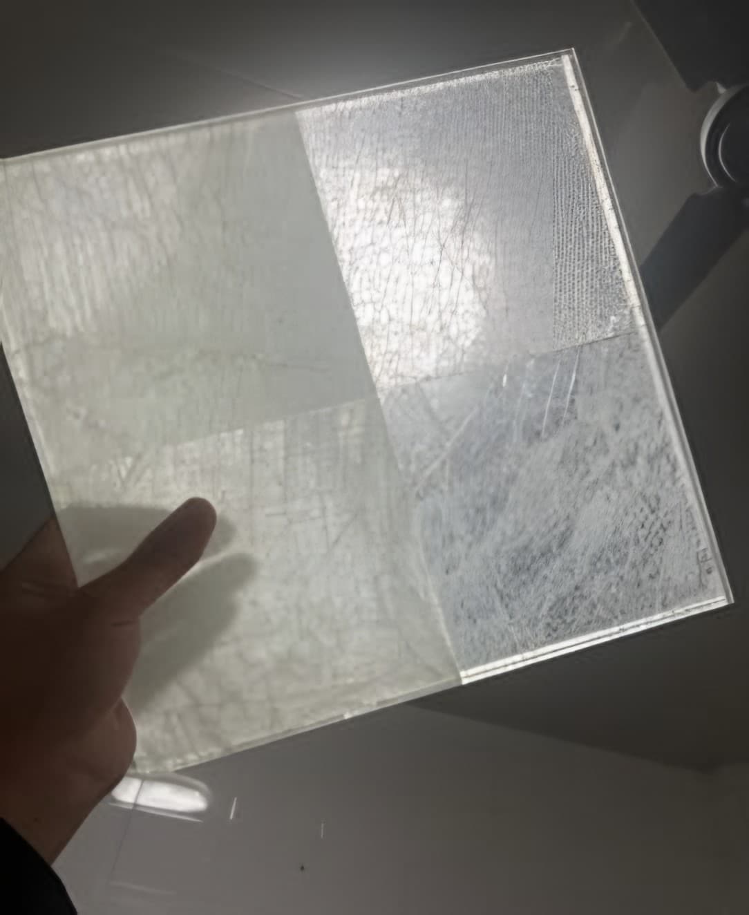 A stone-glass sample held up to the light