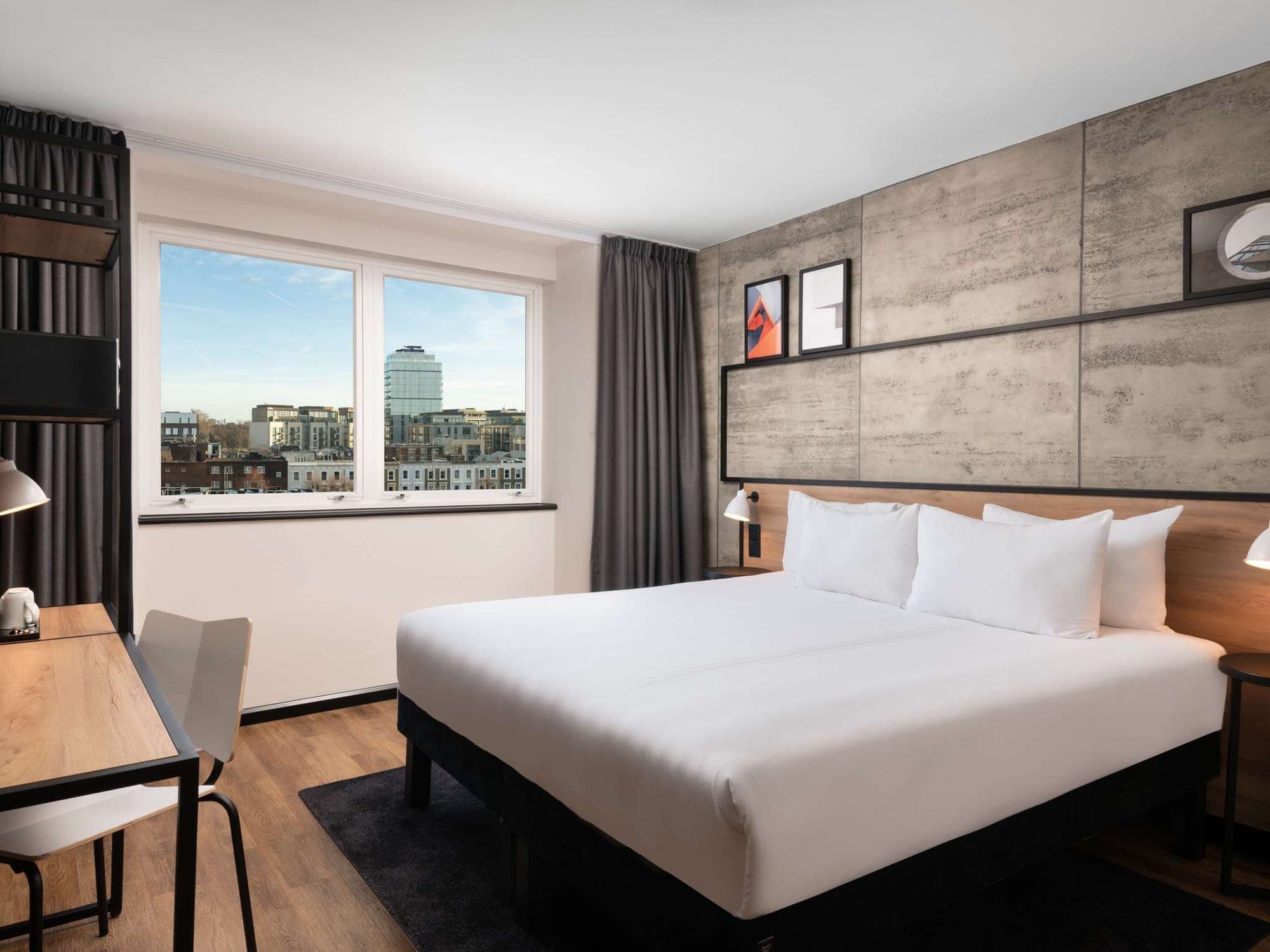 Bedroom with stone-effect walls and a window over the London rooftops