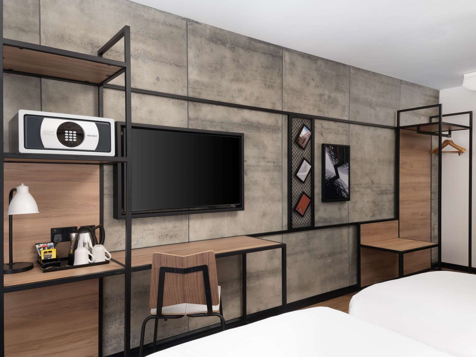 Desk and wall-mounted television against the grey stone-effect cladding