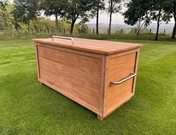 A bamboo storage chest with stainless steel handles, on a golf course