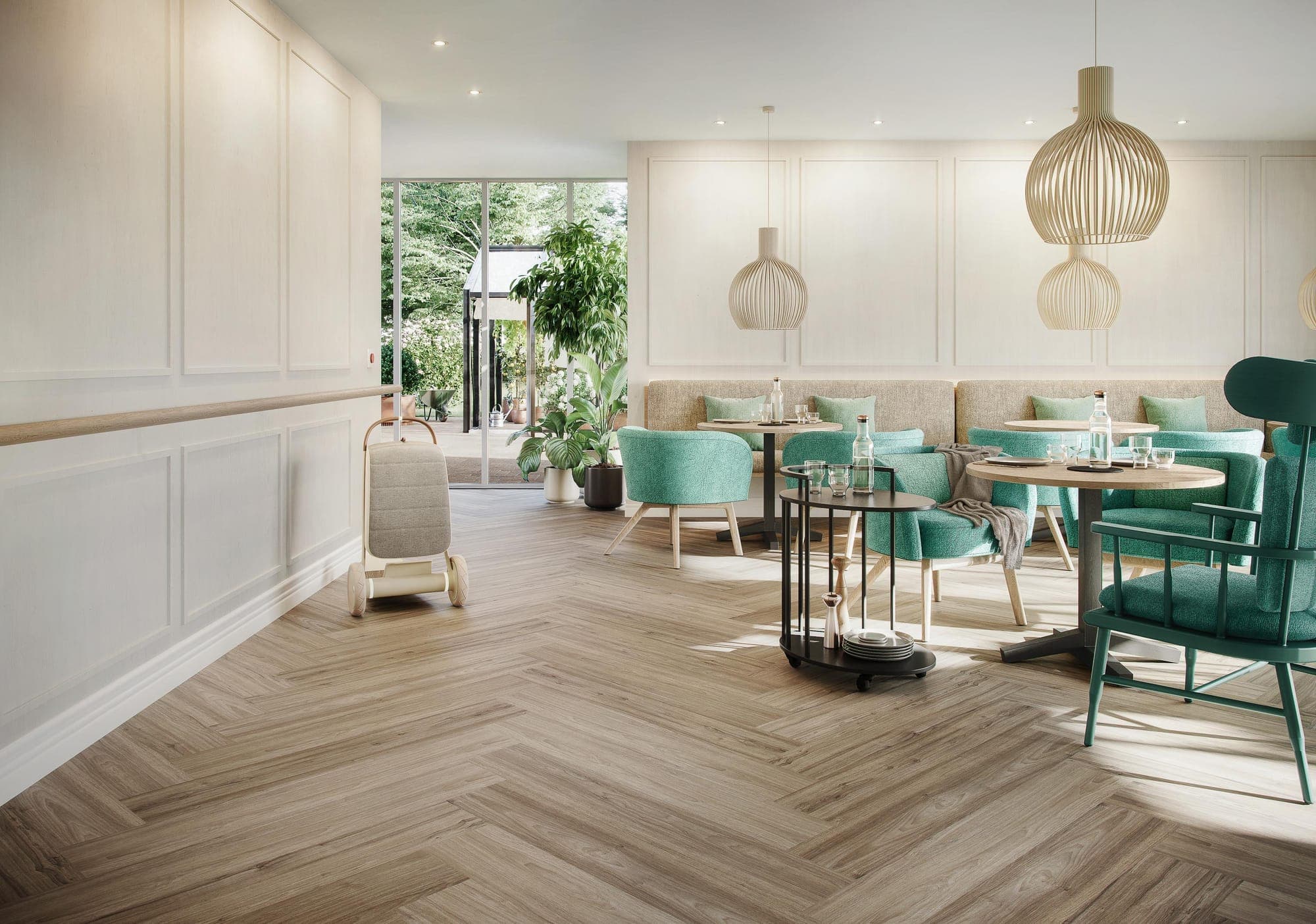 Restaurant with green chairs and panelled walls on a pale oak-effect herringbone floor
