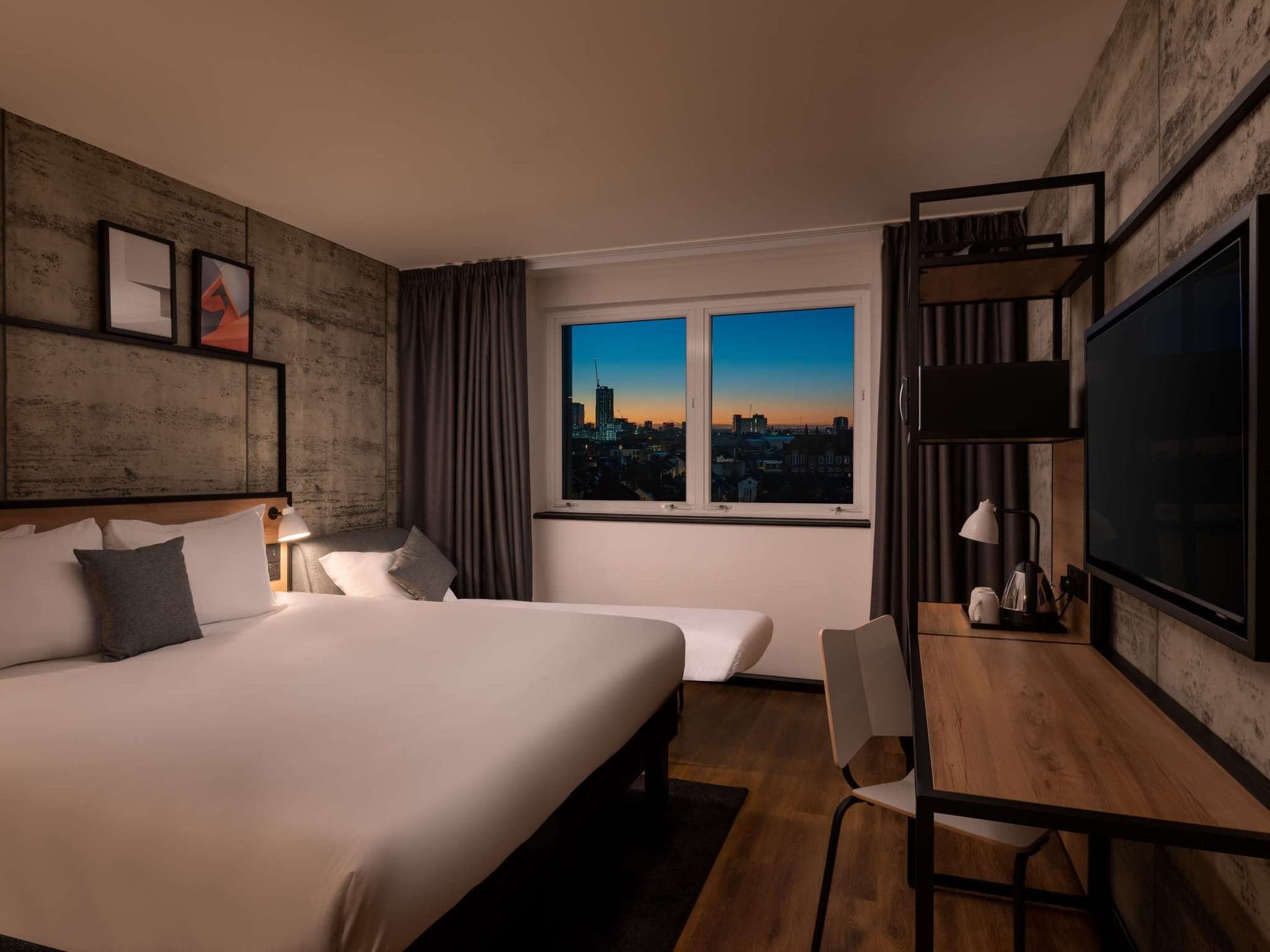 Twin bedroom with the stone-effect cladding running behind both beds