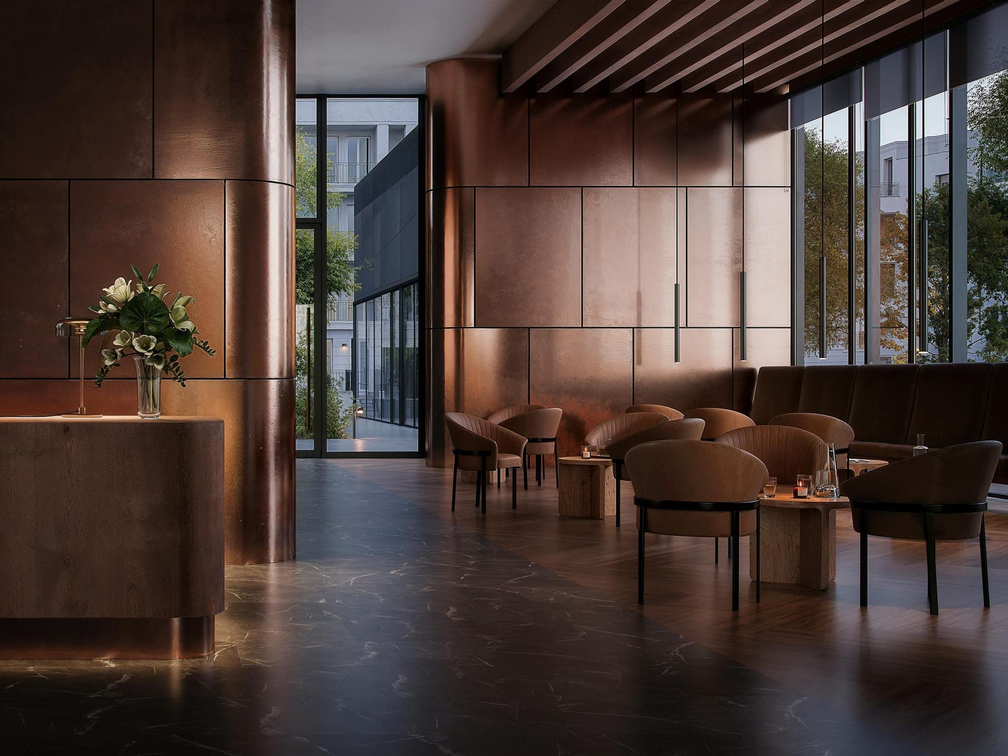 Hotel lounge with copper wall panels and leather chairs on a dark marble-effect floor