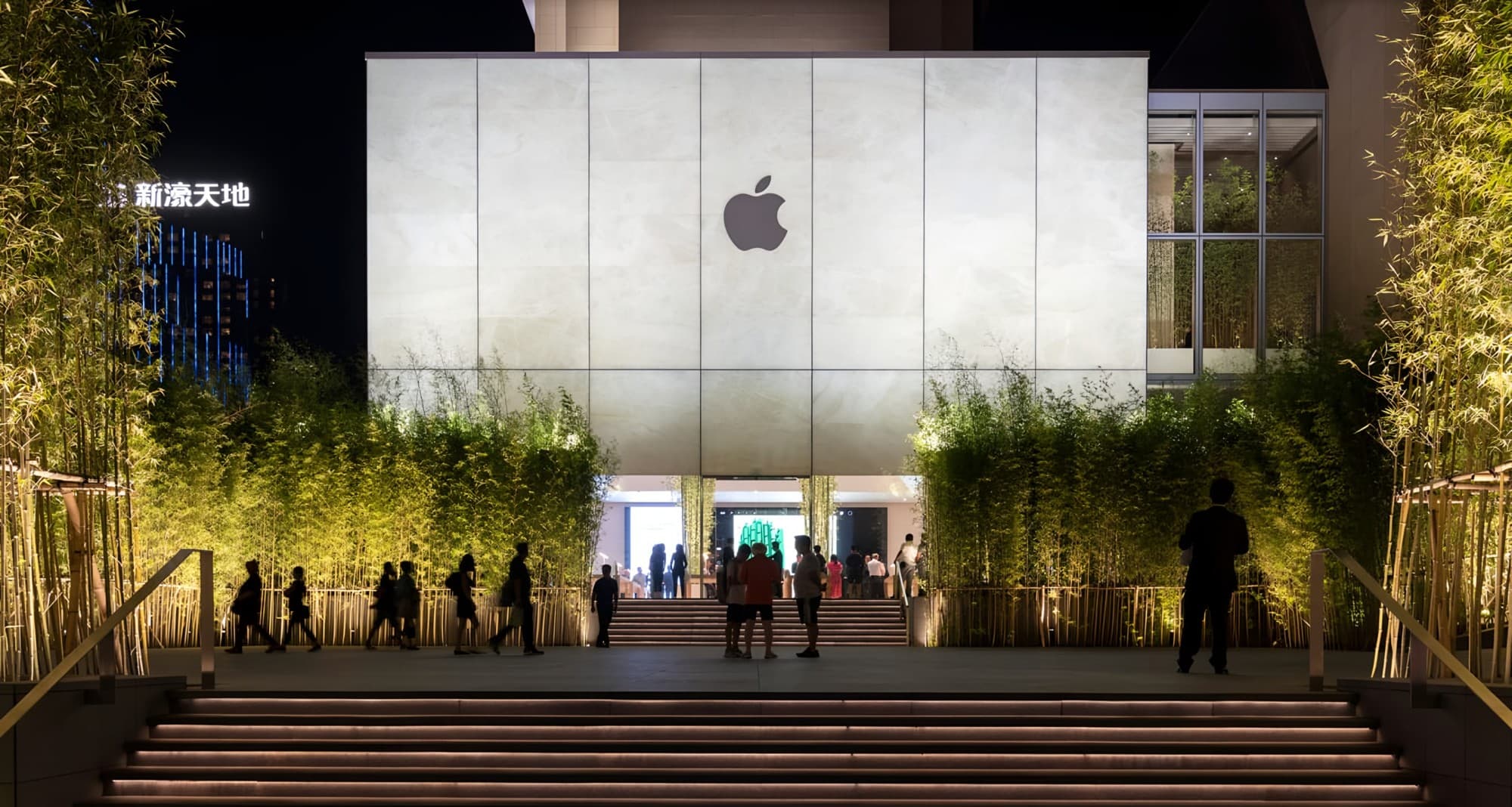 Backlit stone-glass facade glowing at night